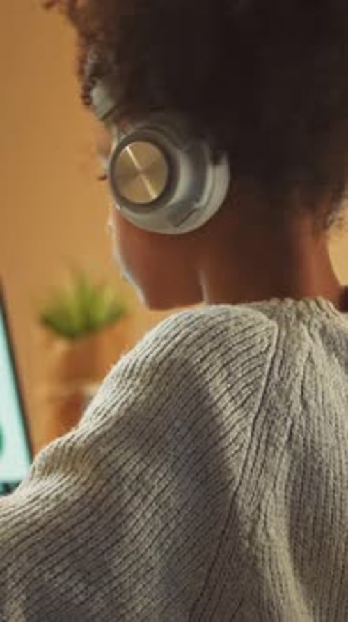 Child Wearing Headphones Uses Laptop