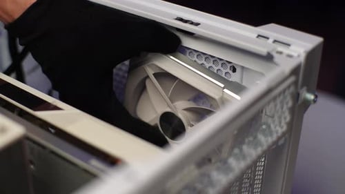 Closeup Hands of Unrecognizable Man in Gloves Installing New Fan in System Unit of Desktop Computer