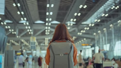 Woman with backpack walking at Airport Terminal, Tourist journey trip concept