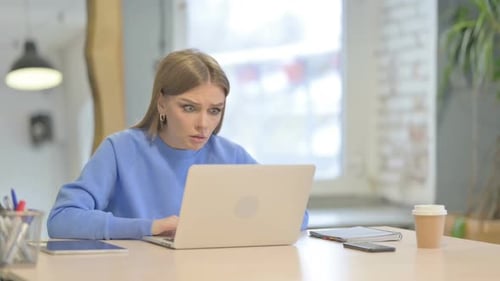 Woman Reacting to Loss While Working in Office