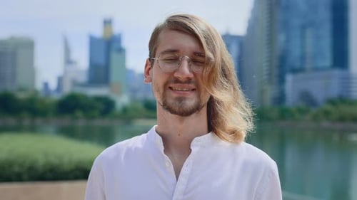 Confident Caucasian Businessman Standing Outside a Business Center Gazing Directly at the Camera