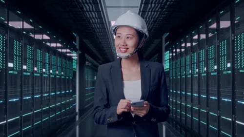 Asian Businesswoman Use Smartphone While Walking and Looking Around in Data Center