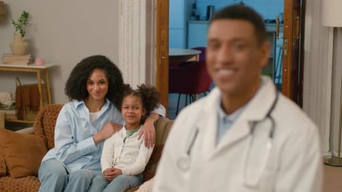 Smiling Doctor with Mother and Child at Home