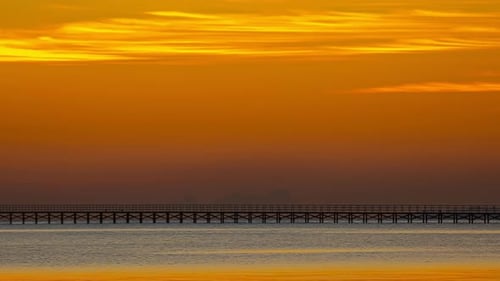 Stunning colorful clouds descending on sunset, beautiful dusk over the ocean