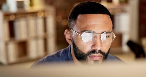 Young Adult Working at Computer in Office Setting