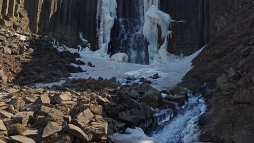 Water Cascading Down Basalt Cliffs Of Studlagil Canyon