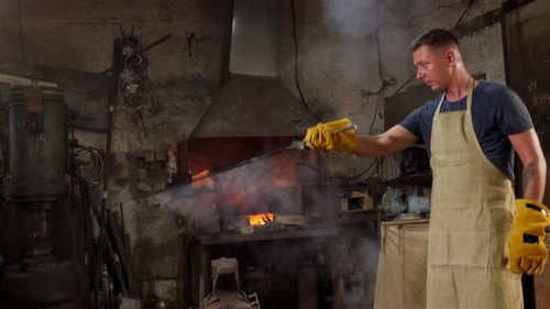 Blacksmith Forging Metal in Smoky Workshop