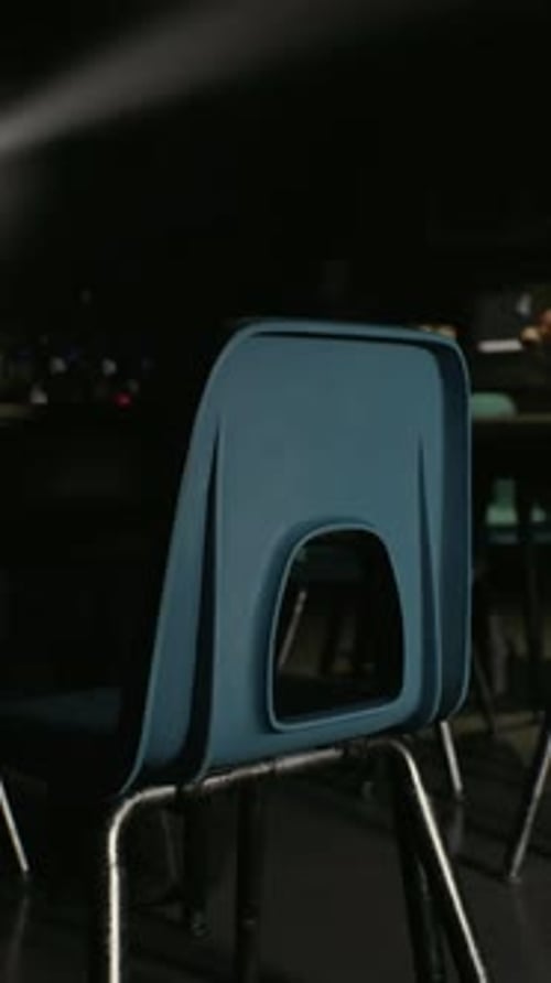 A Row of Blue Chairs in a Dark Room