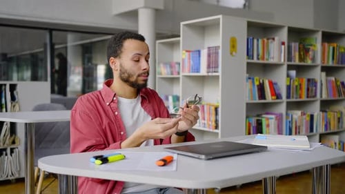 Multitasking African American Student Turns Off Laptop When Finished Working Dissertation in Library