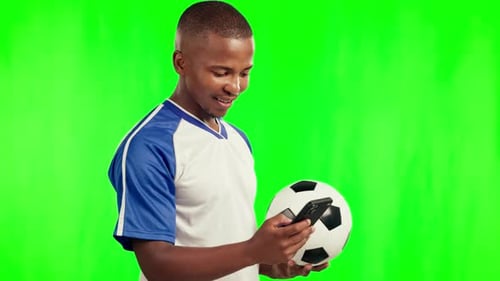 Football, sports and black man with phone on green screen in studio isolated on a background mockup
