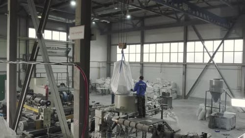 Worker Pours Raw Material From Sack Into Metal Container