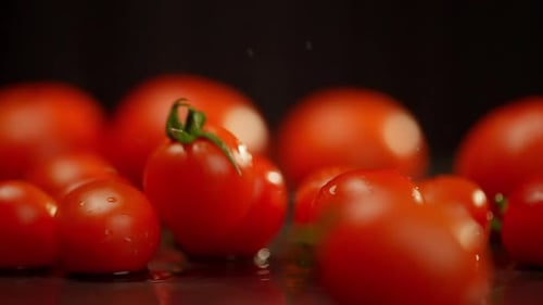 Fresh Red Cherry Tomatoes on Reflective Surface