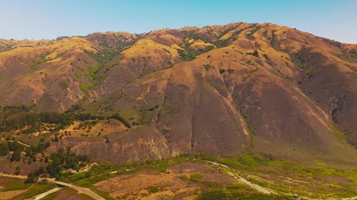 Rolling Golden Mountains Under a Sunny Sky