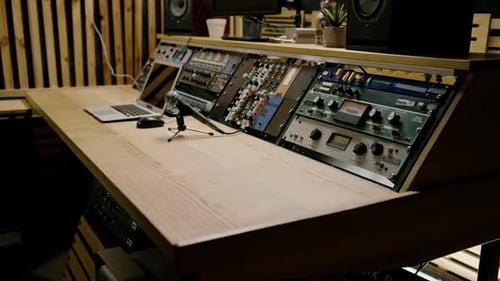 A recording studio control panel mixer with an equalizer faders buttons for broadcasting a recording