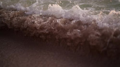 Close-up Of Waves Crashing Onto The Sand Of A Beach In Thailand