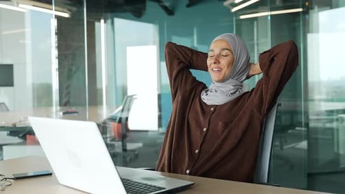 Smiling Woman Working at Laptop in Office