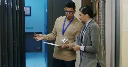 Technicians Inspecting Servers in a Data Center