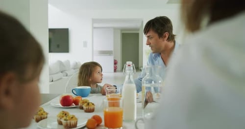 Family Having Breakfast at Kitchen Table