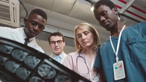 Multiethnic Doctors Team Analyzing MRI of Human Brain