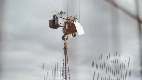 Construction Crane Hook with Chains at Building Site