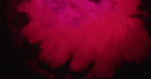 Dramatic pink smoke effect against dark background, abstract design