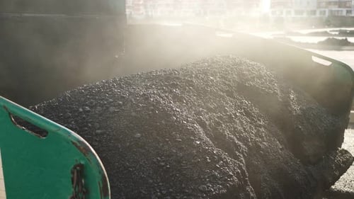 An Asphalt Spreader or an Asphalt Paver Machine on a Road Construction Site