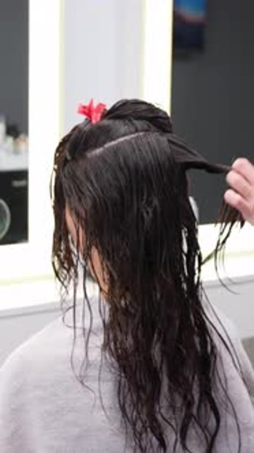 Wet Hair Being Sectioned at Hair Salon