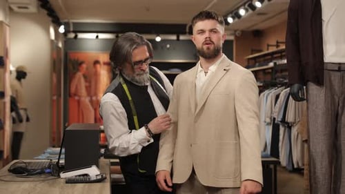 Professional Tailor Taking Measurements of a Client's Suit Jacket