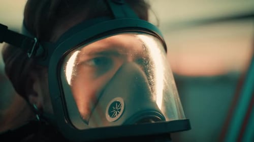 Man Wearing Gas Mask Close Up Looks Around