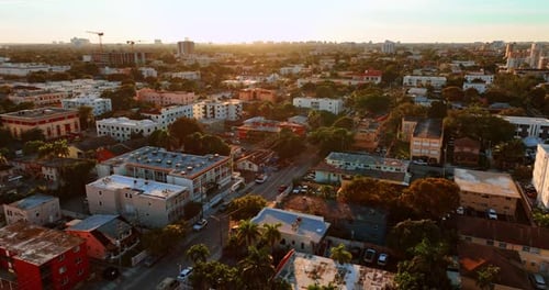 Residential area in Miami with multiple low-rise buildings and lots of trees.