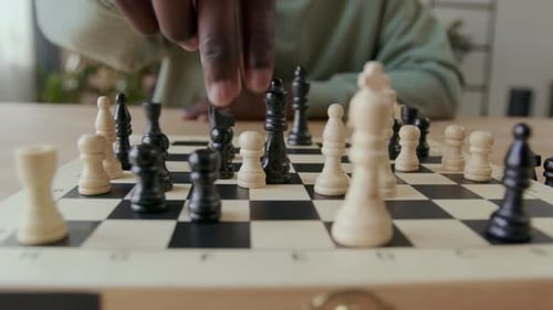 Person Playing Chess at Home During the Day
