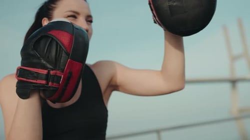 Woman Boxing and Practicing Punches Outdoors