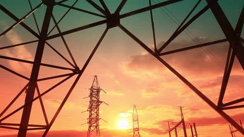 Electrical Pylons Silhouetted Against a Vivid Sunrise