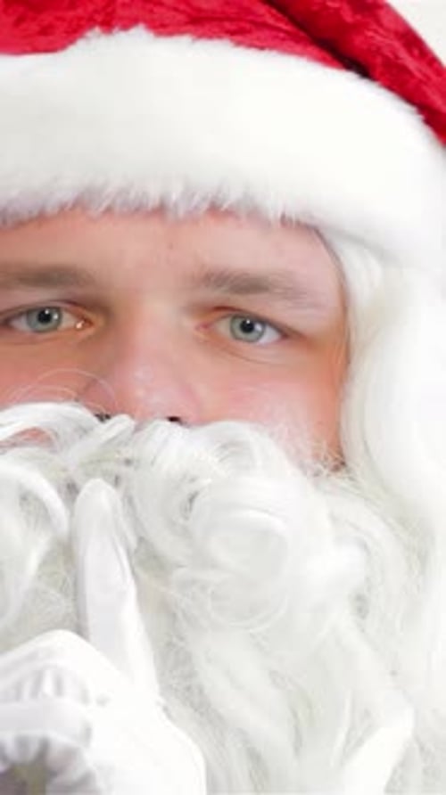 Santa Playfully Gesturing Shh with a Warm Smile