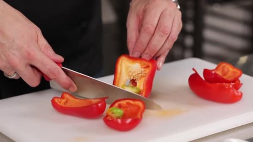 Person Cutting Red Bell Pepper with Knife