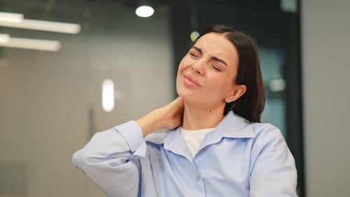 Woman Suffering Neck Pain and Discomfort at Office