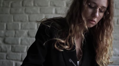 Young Woman Working on Her Laptop Computer in Coffee Shop