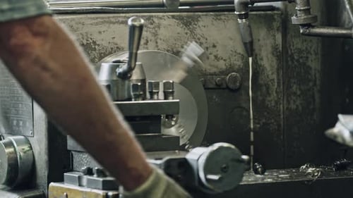 Precisión de moldeado de metales: el trabajador opera la máquina de torno en el taller