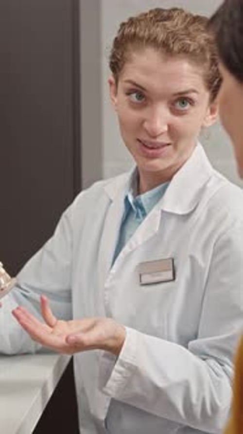 Female Dentist Giving Consultation to Patient at Clinic