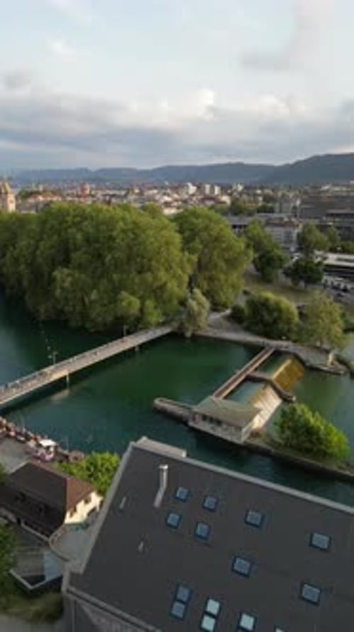 Aerial video of people vacationing along a river in Zurich, Switzerland