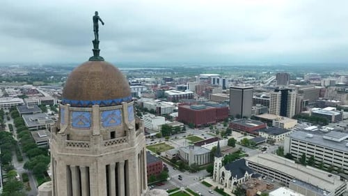 Nebraska state capitol building with Lincoln skyline. Aerial establishing shot.