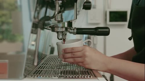 Barista is making coffee in coffee shop