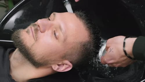 Man Getting Hair Washed at a Salon