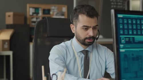 Biracial Cybersecurity Officer Working on Computer in Office