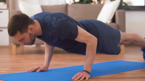 Man Doing Push Ups on Blue Exercise Mat