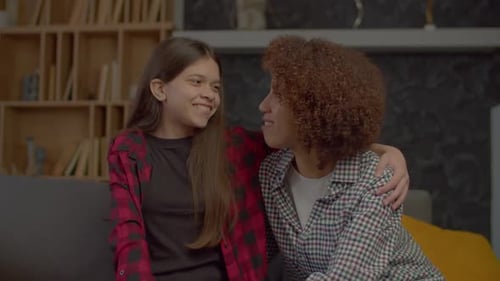 Girl Smiling While Talking With Woman Indoors