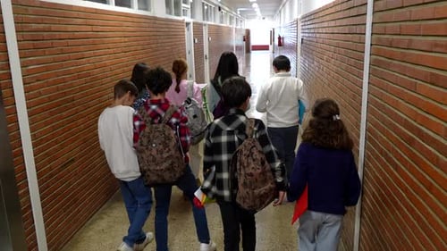 Students walking in school corridor