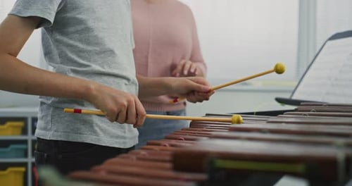 Close Up of Primary School Boy Practicing Xylophone in Modern Music Class with Teacher