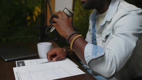 Man Recording Podcast Episode With Microphone and Computer