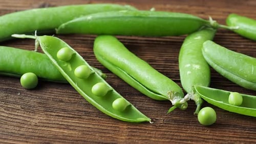 Bright Green Pea Pods on Rustic Wood Table